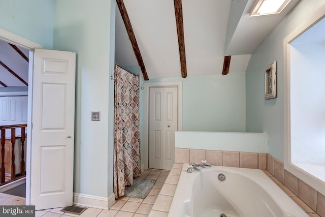 bathroom with tile patterned flooring, lofted ceiling with beams, and tiled tub