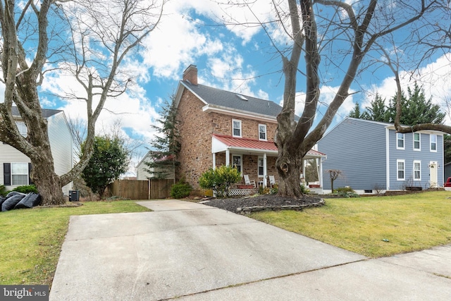 view of front of house with a front yard and covered porch