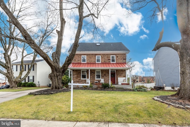 view of front of house with a porch and a front lawn