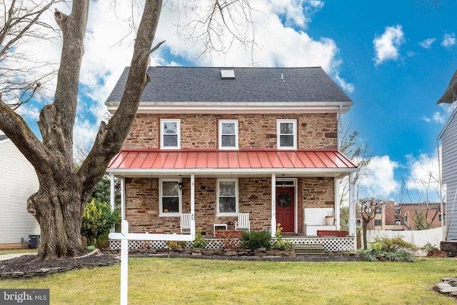 view of front of home featuring a front yard, a porch, and central air condition unit