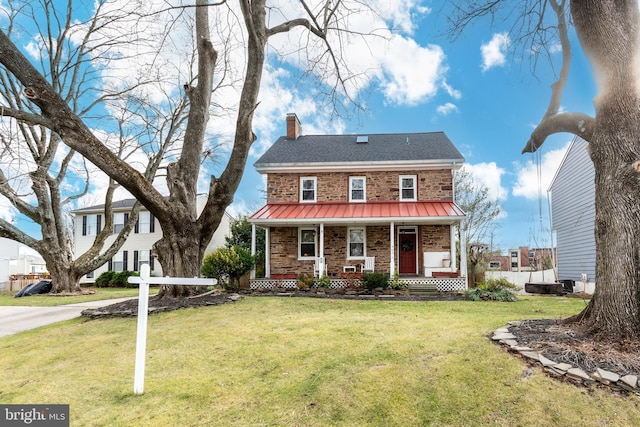 colonial home with a porch and a front lawn