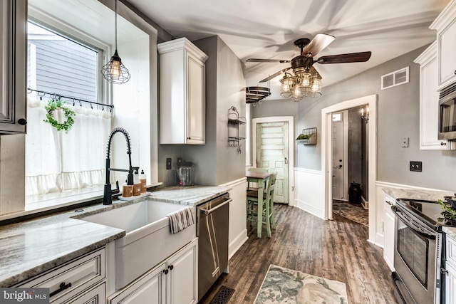 kitchen featuring white cabinetry, light stone countertops, and appliances with stainless steel finishes