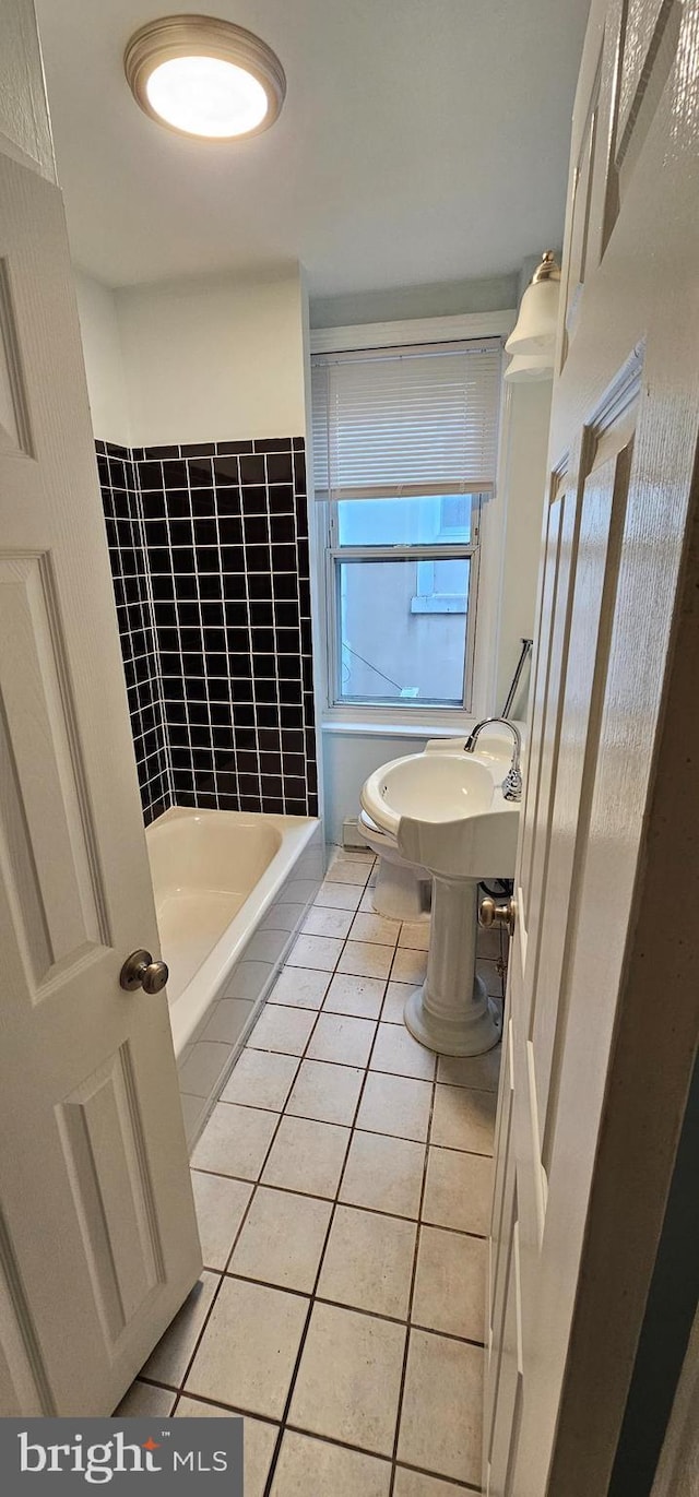 bathroom with tile patterned flooring and tiled shower / bath combo