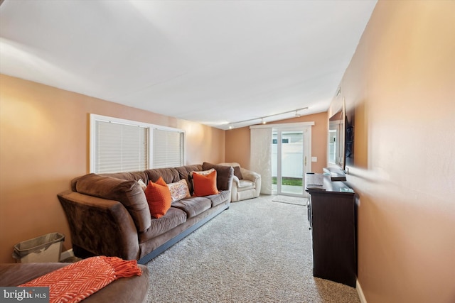 carpeted living room featuring track lighting