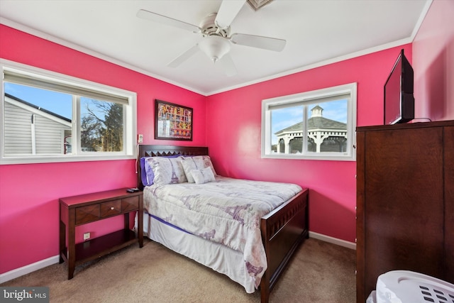 bedroom with carpet flooring, ceiling fan, ornamental molding, and multiple windows