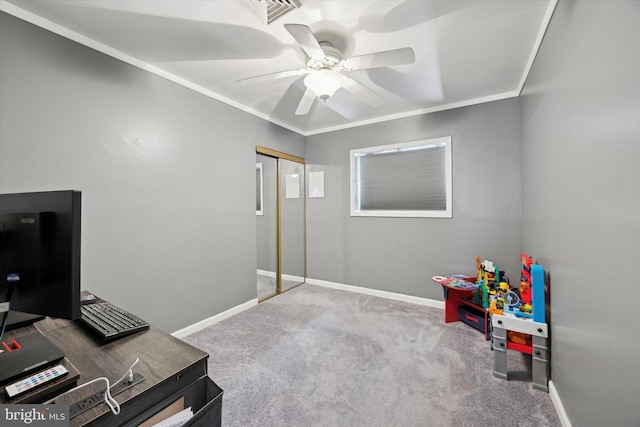 carpeted office space featuring ceiling fan and crown molding