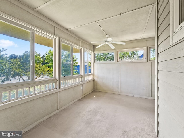 unfurnished sunroom featuring ceiling fan