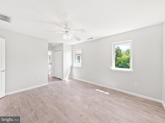 spare room with light hardwood / wood-style floors and ceiling fan