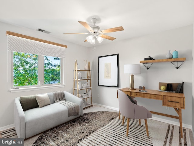 office area featuring ceiling fan and light carpet