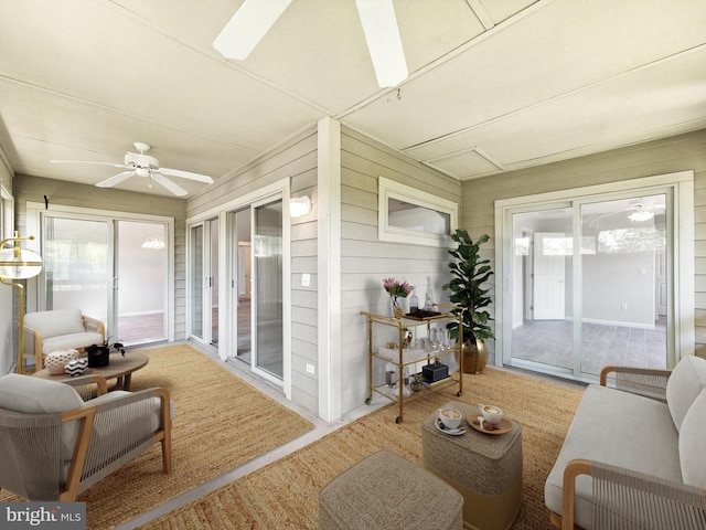 sunroom / solarium featuring ceiling fan