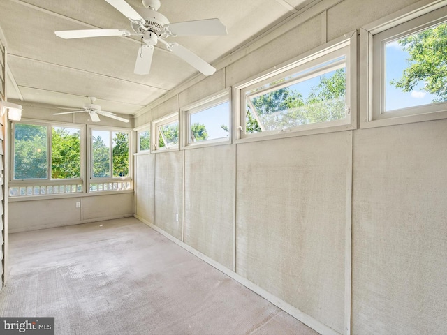 unfurnished sunroom featuring ceiling fan and a healthy amount of sunlight