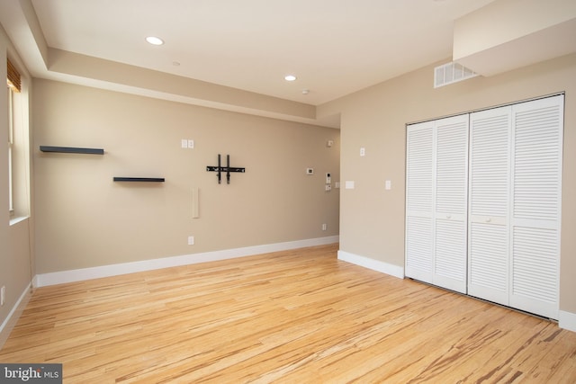 unfurnished bedroom featuring a closet and light wood-type flooring