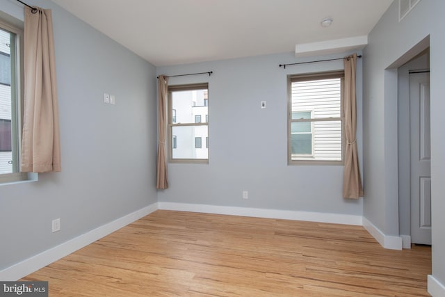 empty room with light hardwood / wood-style flooring