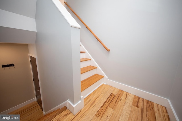 stairway with hardwood / wood-style floors