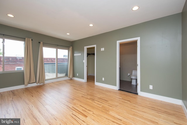 empty room with light hardwood / wood-style flooring