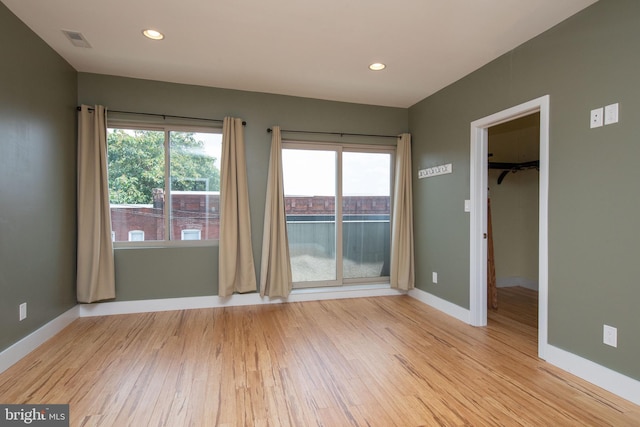 unfurnished room with light hardwood / wood-style floors