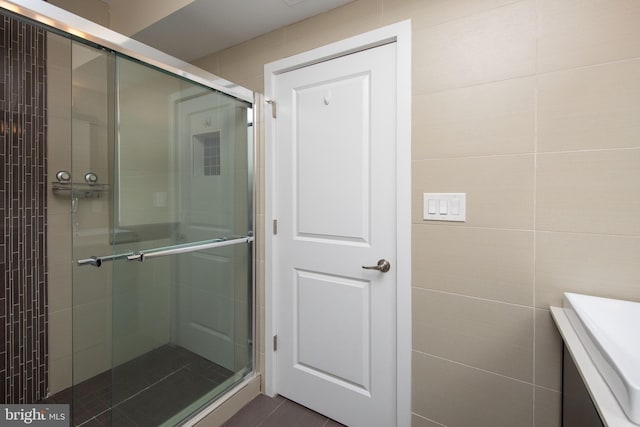 bathroom featuring a shower with shower door