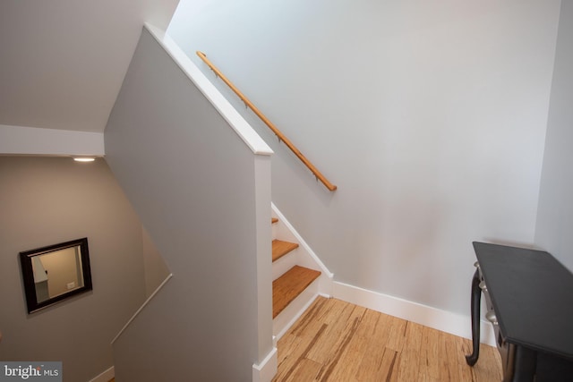 stairway featuring wood-type flooring