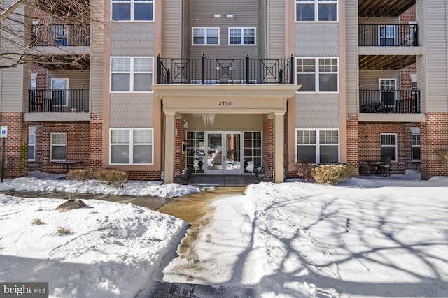 view of snow covered property entrance