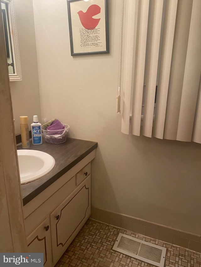 bathroom featuring tile patterned flooring and vanity