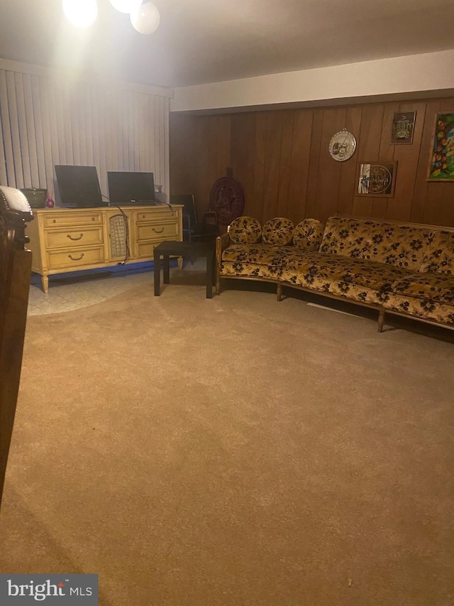 carpeted bedroom featuring wooden walls