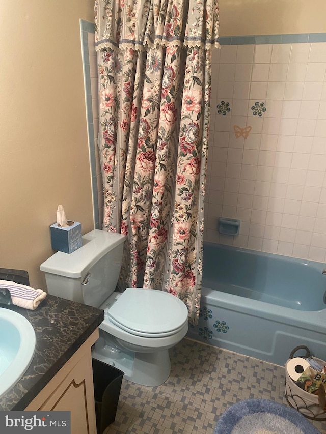 full bathroom with tile patterned floors, vanity, shower / tub combo, and toilet