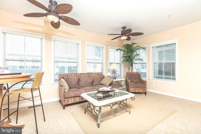 sunroom / solarium featuring ceiling fan