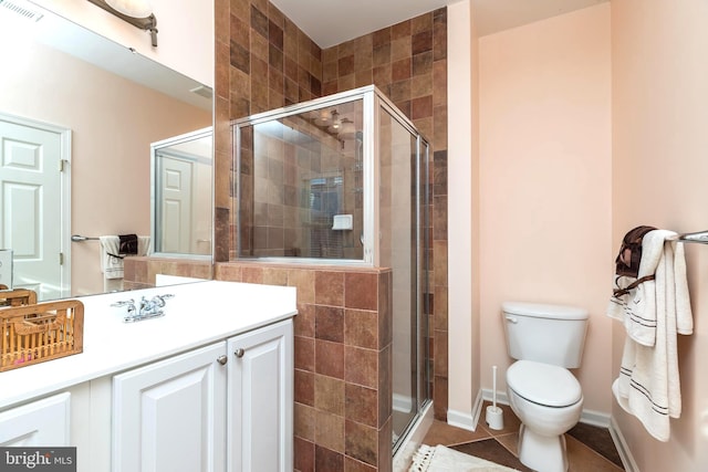 bathroom with vanity, toilet, an enclosed shower, and tile patterned flooring