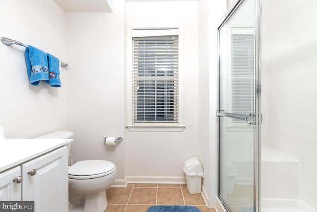 bathroom with toilet, a shower with door, vanity, and tile patterned flooring