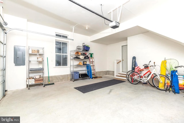 garage featuring electric panel and a garage door opener