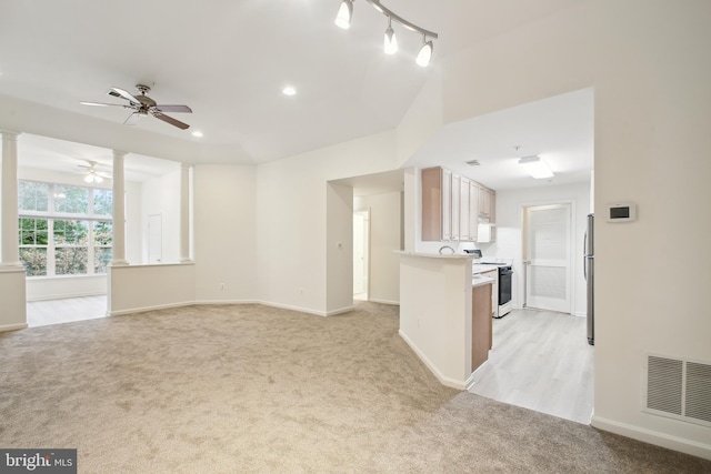 interior space with ceiling fan and light carpet