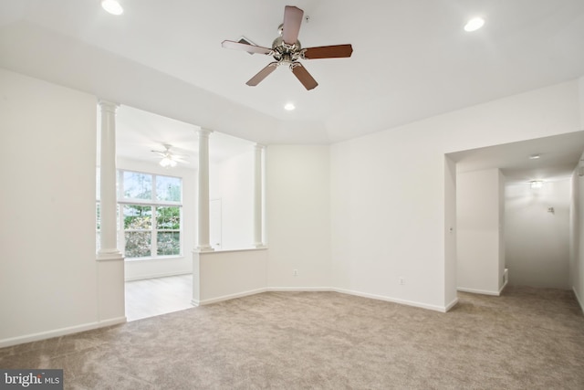 carpeted spare room featuring ceiling fan and lofted ceiling