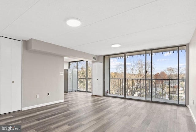 interior space with hardwood / wood-style flooring and expansive windows