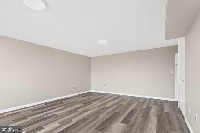 unfurnished room featuring dark wood-type flooring