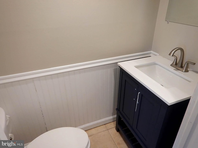 bathroom with tile patterned floors, vanity, and toilet