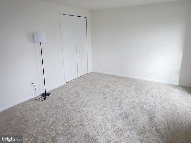 unfurnished bedroom with carpet and a closet