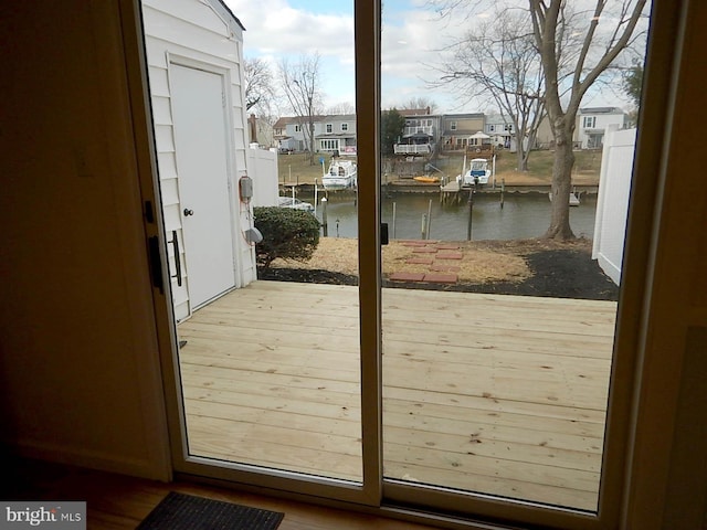 entryway with a water view and wood-type flooring