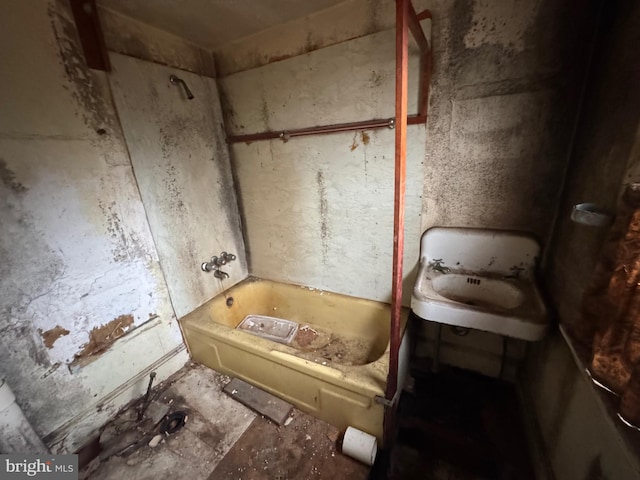 bathroom with sink and a tub to relax in