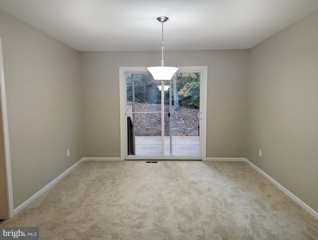 unfurnished dining area with carpet