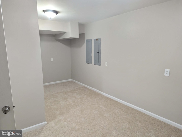 empty room with electric panel and light colored carpet