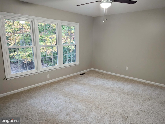 carpeted empty room with ceiling fan