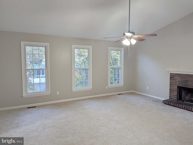 unfurnished living room featuring ceiling fan, light colored carpet, lofted ceiling, and a fireplace