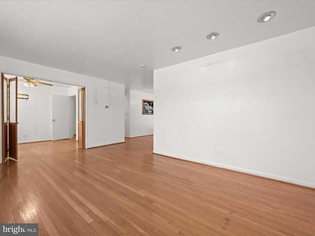 spare room featuring ceiling fan and light hardwood / wood-style flooring