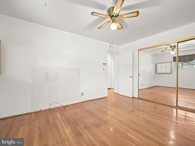 unfurnished bedroom with ceiling fan, a closet, and light hardwood / wood-style flooring