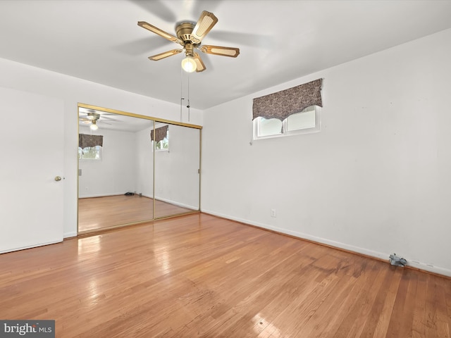 spare room with hardwood / wood-style flooring and ceiling fan