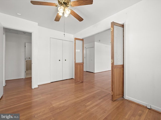 unfurnished bedroom featuring hardwood / wood-style flooring and ceiling fan