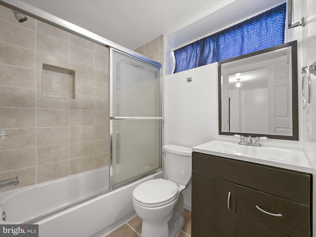 full bathroom featuring combined bath / shower with glass door, toilet, tile patterned floors, and vanity