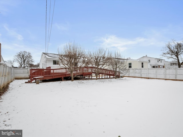 snowy yard with a deck