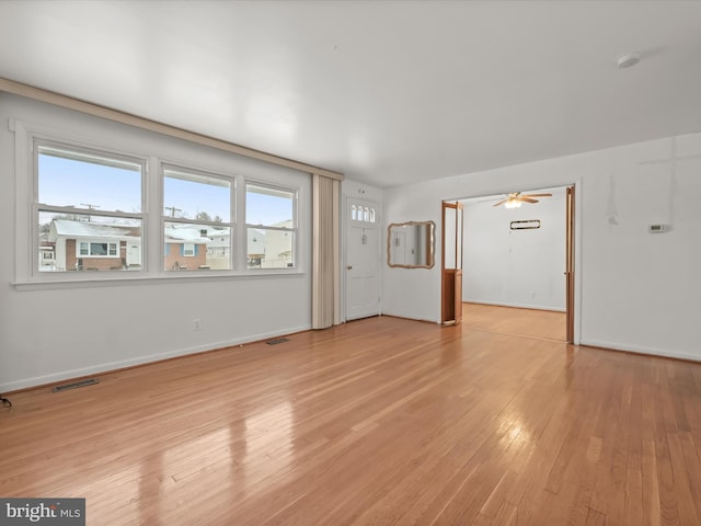 unfurnished living room featuring light hardwood / wood-style floors, plenty of natural light, and ceiling fan