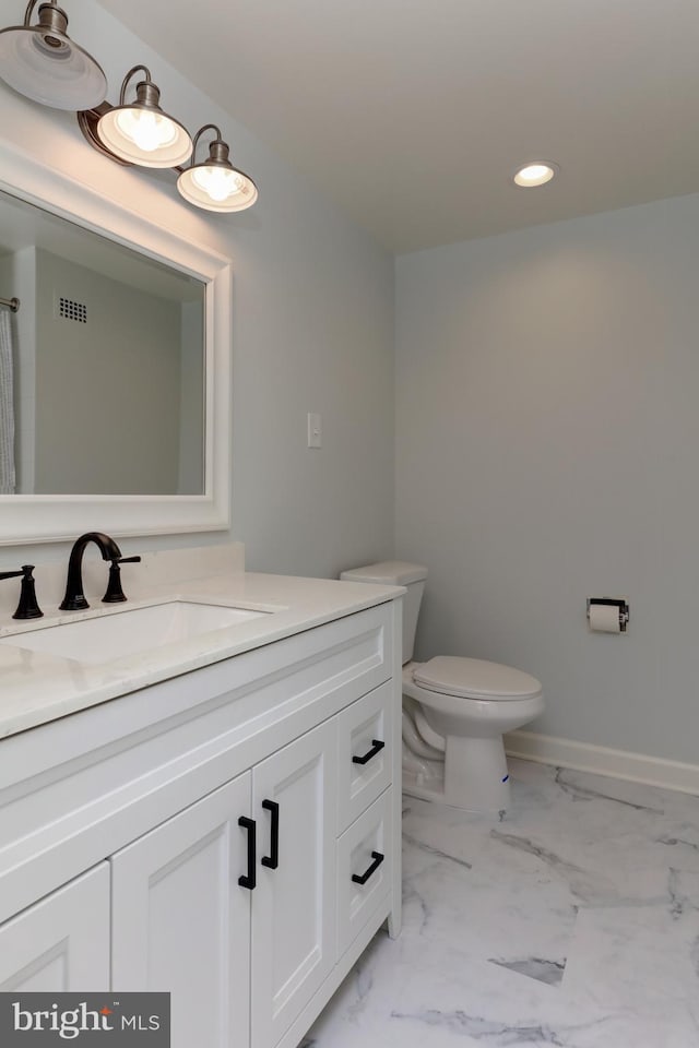 bathroom featuring vanity and toilet